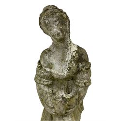 Weathered and painted cast stone garden statue, in the form of an Italian maiden with an ornate tied hairstyle and flowing gown, holding a wounded dove, on a turned base with garland decoration