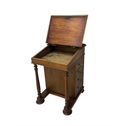 19th century pitch pine Davenport desk, sloping hinged top, fitted with four drawers, on turned column supports, turned compressed feet with castors 