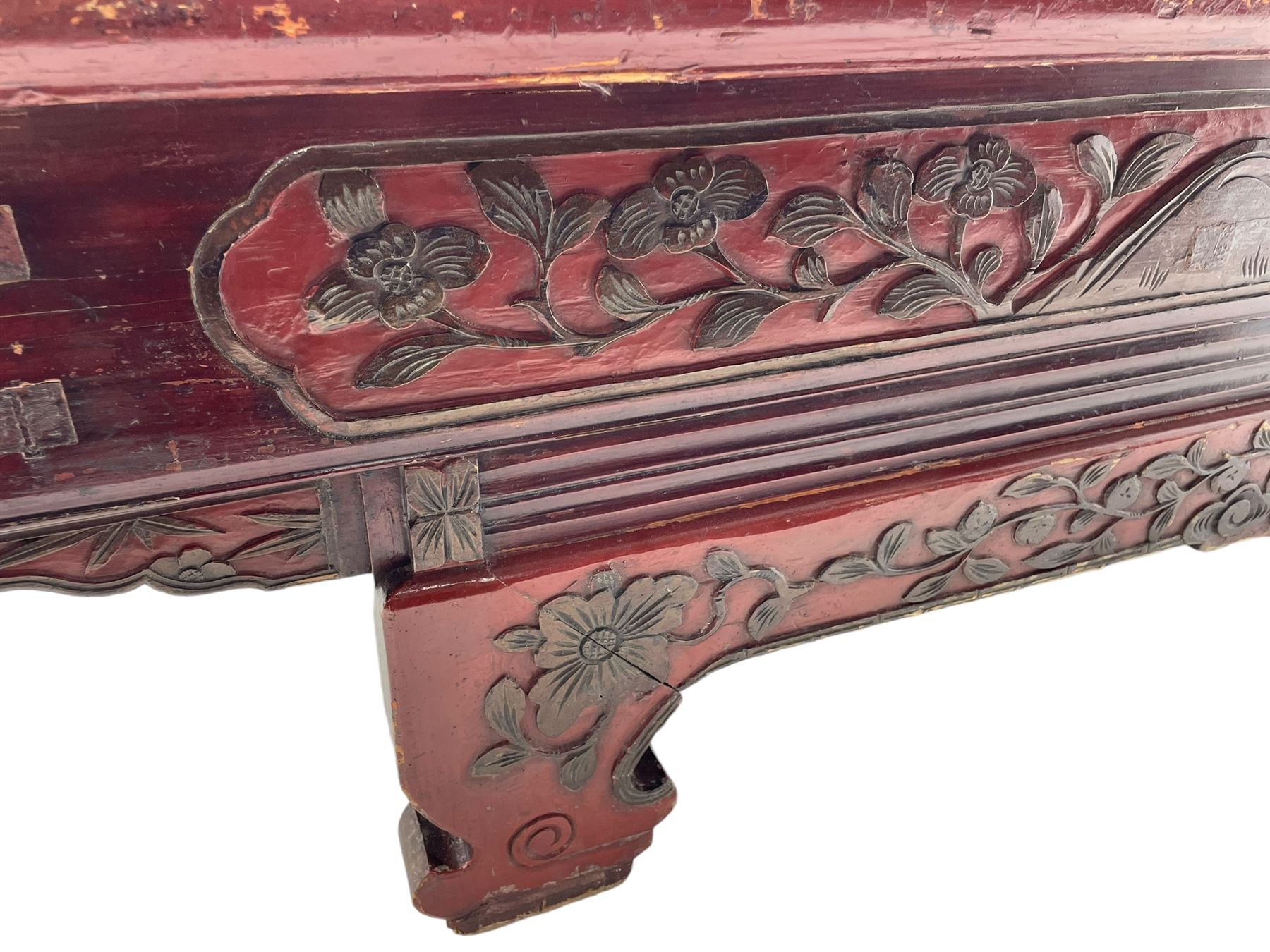 Mid-19th century Qing dynasty opium or wedding bed, Zhejiang province, rectangular top with weave cane work, the frieze rail carved with trailing leafy branches and flower heads, over moulded rail with small drawer, shaped base carved with further tailing foliate decoration terminating to shaped feet, united by stretchers 