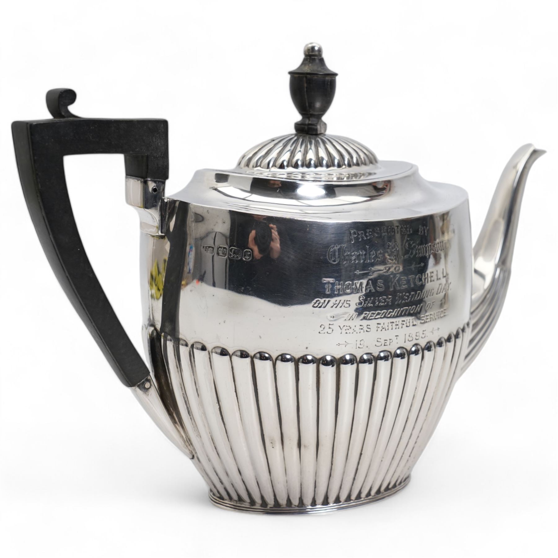 Late Victorian silver oval teapot with ebonised handle and lift, half body reeded decoration and presentation inscription Sheffield 1895 Maker Atkin Bros.