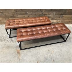 Two rectangular metal framed benches, upholstered in buttoned tan leather