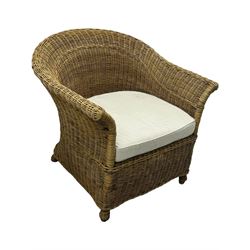 Rattan armchair and ottoman set, pair of armchairs featuring rounded backrests with wide armrests, woven wicker frame with weaving and upholstered seat cushions in off-white fabric with flowing floral pattern (W83 D80 H78cm); matching round ottoman with upholstered cushion on square wooden feet (W65 D65 H37cm)