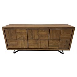 Samba 'Camden' oak sideboard, rectangular top over three block panelled cupboard doors, raised on angled black metal supports connected with stretcher