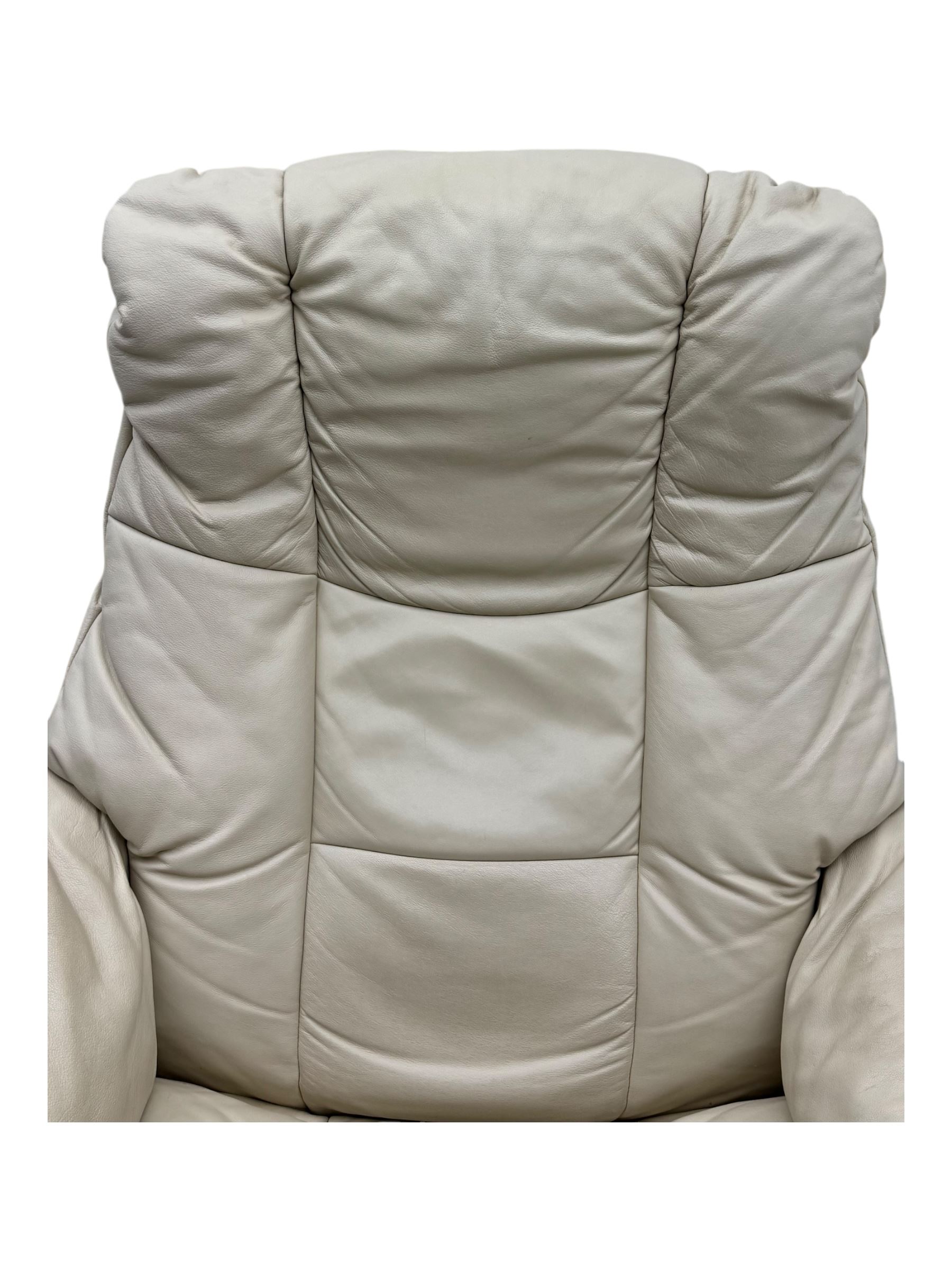 Ekornes Stressless - swivel armchair upholstered in cream leather (W81cm, H103cm); together with matching stool (W49cm)