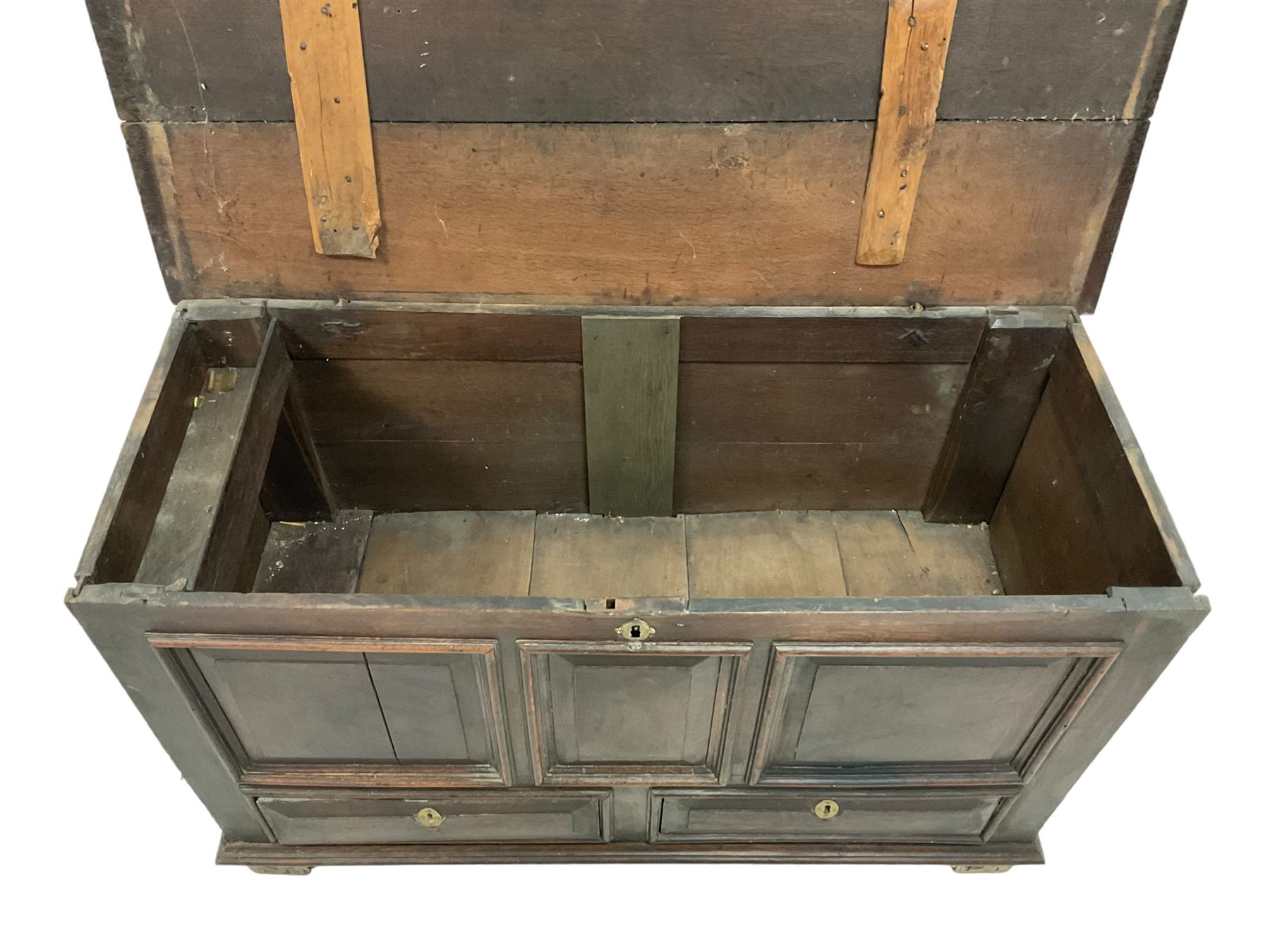 18th century oak mule chest, rectangular hinged top with moulded edge enclosing candle box, triple panelled font over two drawers with fielded panelled facias, on stile supports