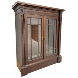 19th century mahogany display cabinet, rectangular top over frieze decorated with Vitruvian scroll mount, enclosed by two astragal glazed doors, the upright rails decorated with trailing bellflowers, on moulded plinth