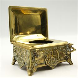 Victorian and later inkwells to include a brass casket form inkwell with hinged cover, a novelty inkwell in the form of a coal bucket with swing handle and leather covered inkwell, various glass examples, together with an early 20th century silver mounted match stick holder/ striker 