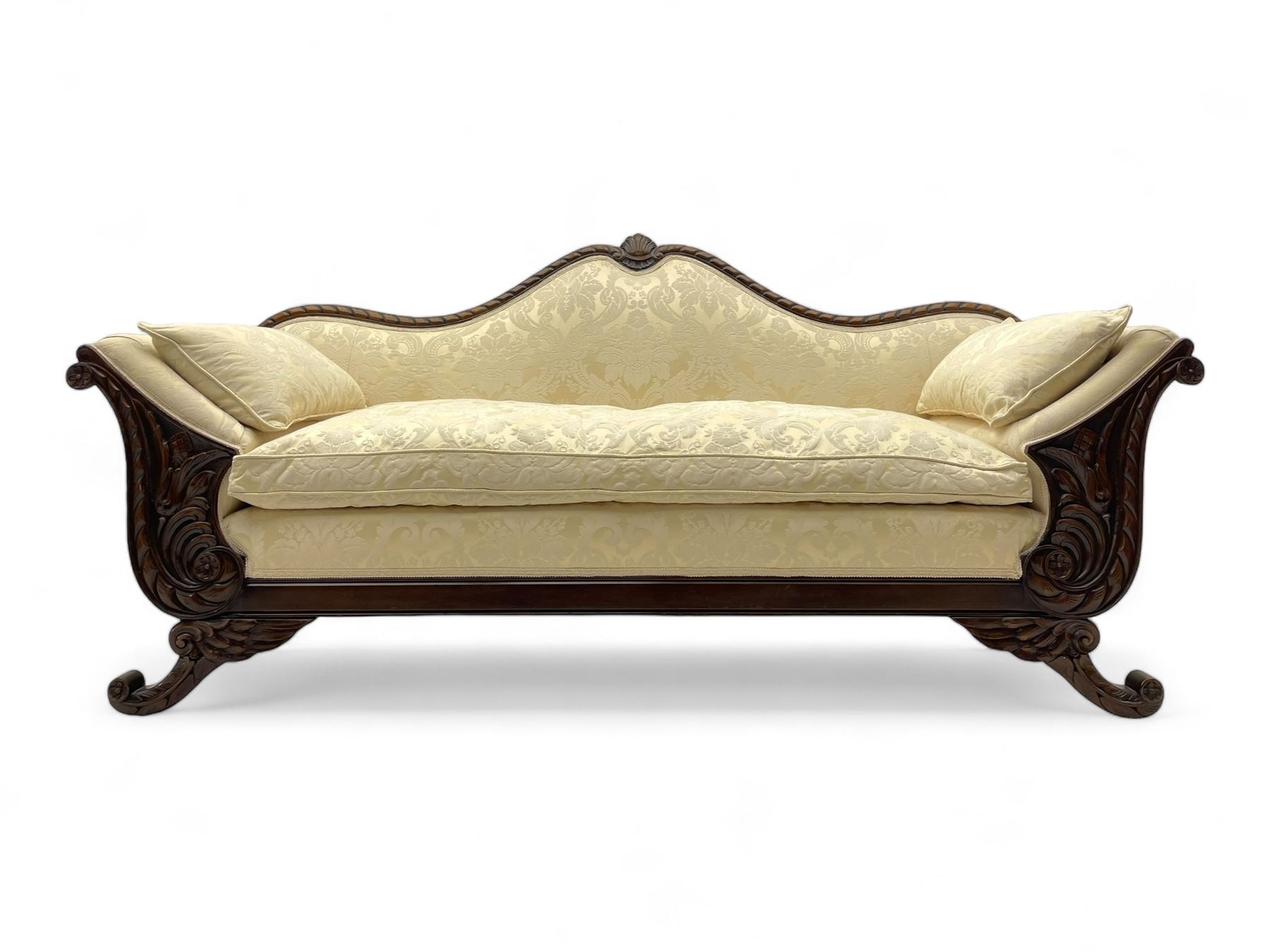 Victorian design walnut framed settee, shaped camelback with gadroon carved edge and central feather motif, upholstered in cream damask fabric with scrolling floral pattern, S-scroll arm facias carved with flower head and curled leaves, feather carved C-scroll splayed feet 