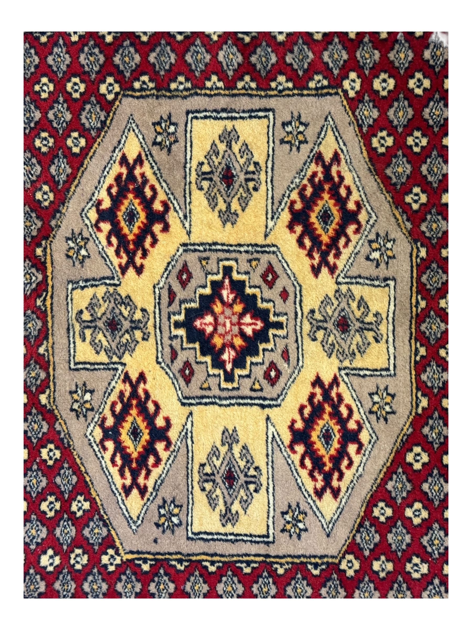 Pakistani Kashan hand-knotted rug with a central medallion and intricate geometric floral patterns, set against a red field and framed by a multi-band border; Pakistani Kashan rug with a repeating floral motif across the red field, enclosed by a detailed geometric border in complementary tones (2)