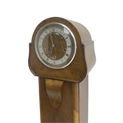 English - 1950's walnut 8-day quarter chiming grandmother clock, rounded top with a splayed base on bracket feet, wooden dial centre with a silvered chapter dial, chrome hands and roman numerals enclosed within a chrome bezel, three train going barrel movement chiming the quarters and hours on 8 gong rods. With pendulum.