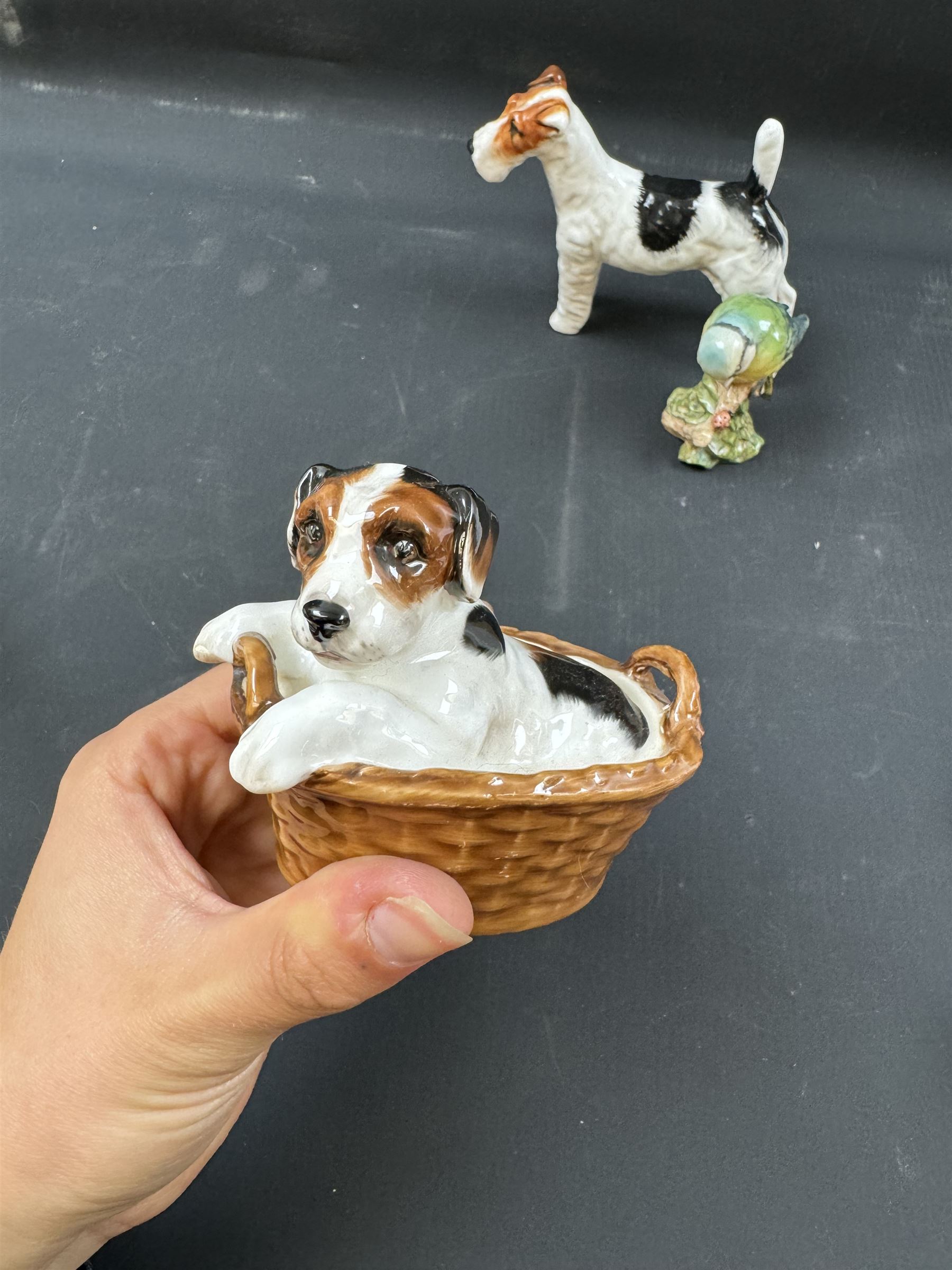 Two Royal Doulton figures of puppies in baskets, together with Beswick horse and other animal figures