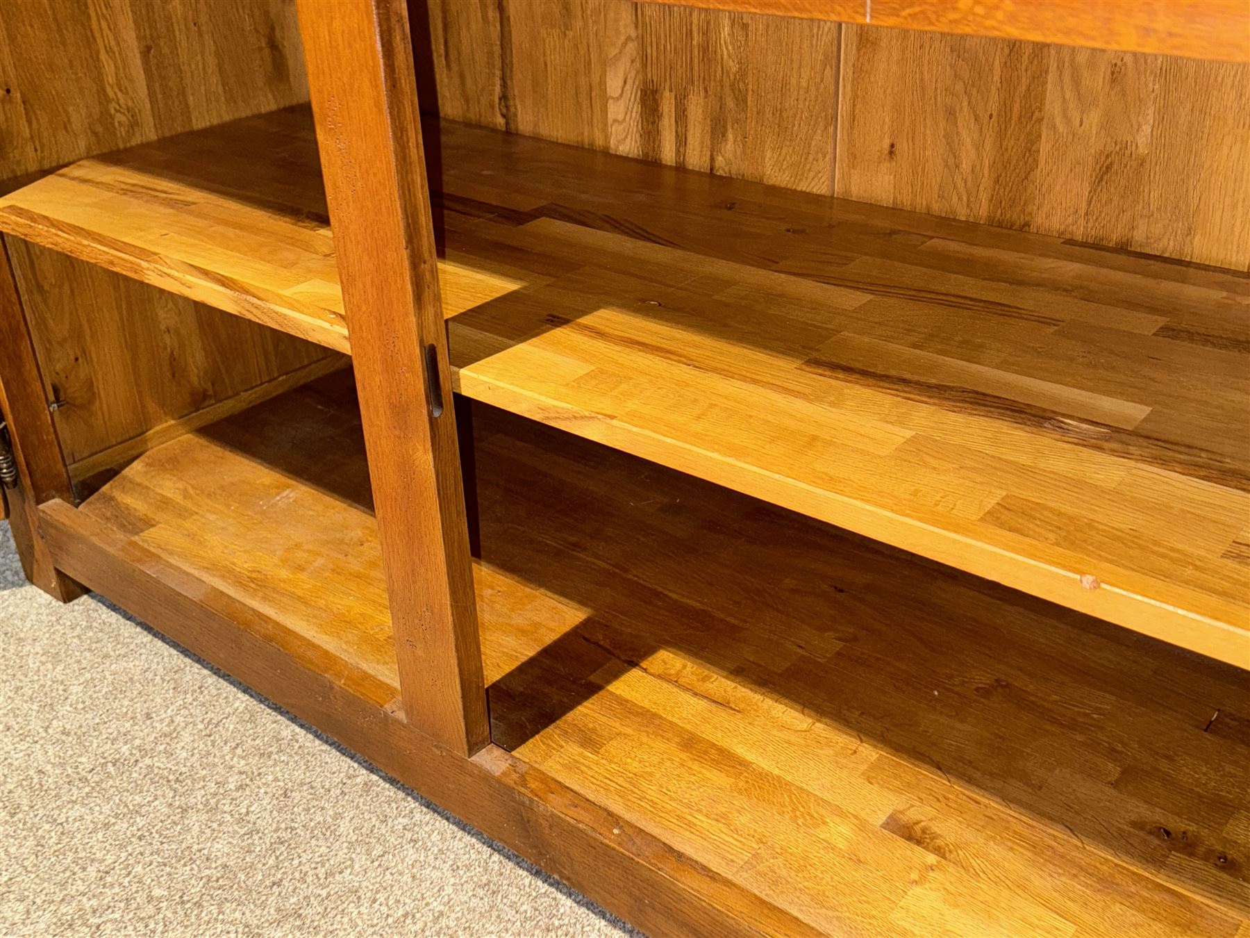 Large 20th century oak dresser, projecting cornice over open arched central section with two shelves, flanked by two panelled cupboards with two shelves, lower section with three drawers above three cupboards, on stile supports 