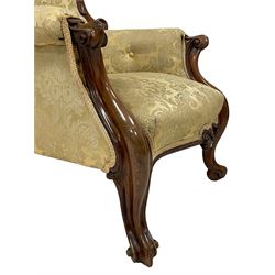 Victorian mahogany framed armchair, shaped and moulded frame carved with curled foliage, upholstered in pale gold floral pattern silk damask fabric, scrolled arm terminals on shaped moulded supports terminating to scroll carved feet