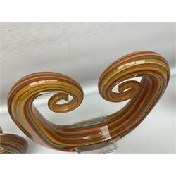 Three art glass sculpture, coiled form with multicolour stranded, upon clear glass plinth, unsigned, largest H27cm