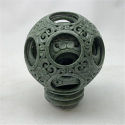 A carved soapstone puzzle ball, with seven concentric bands, upon a soapstone stand, including stand H15.5cm, together with a Japanese bronzed planter on stand, of hexagonal form, decorated with fret pattern and phoenixes, H12.5cm. 