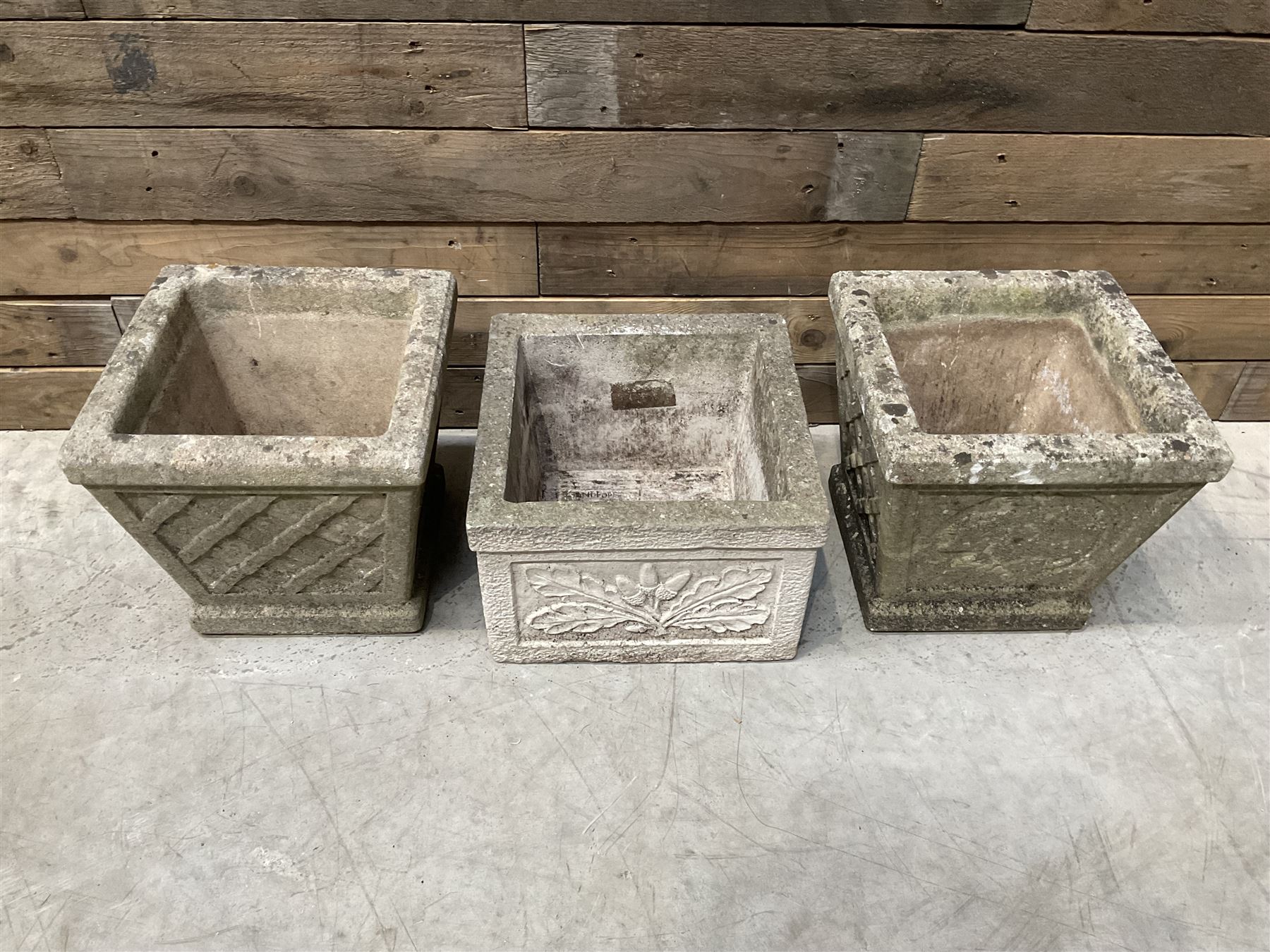 Pair of square cast stone planters, single planter with leaf decoration and a rectangular brick effect planter (4)