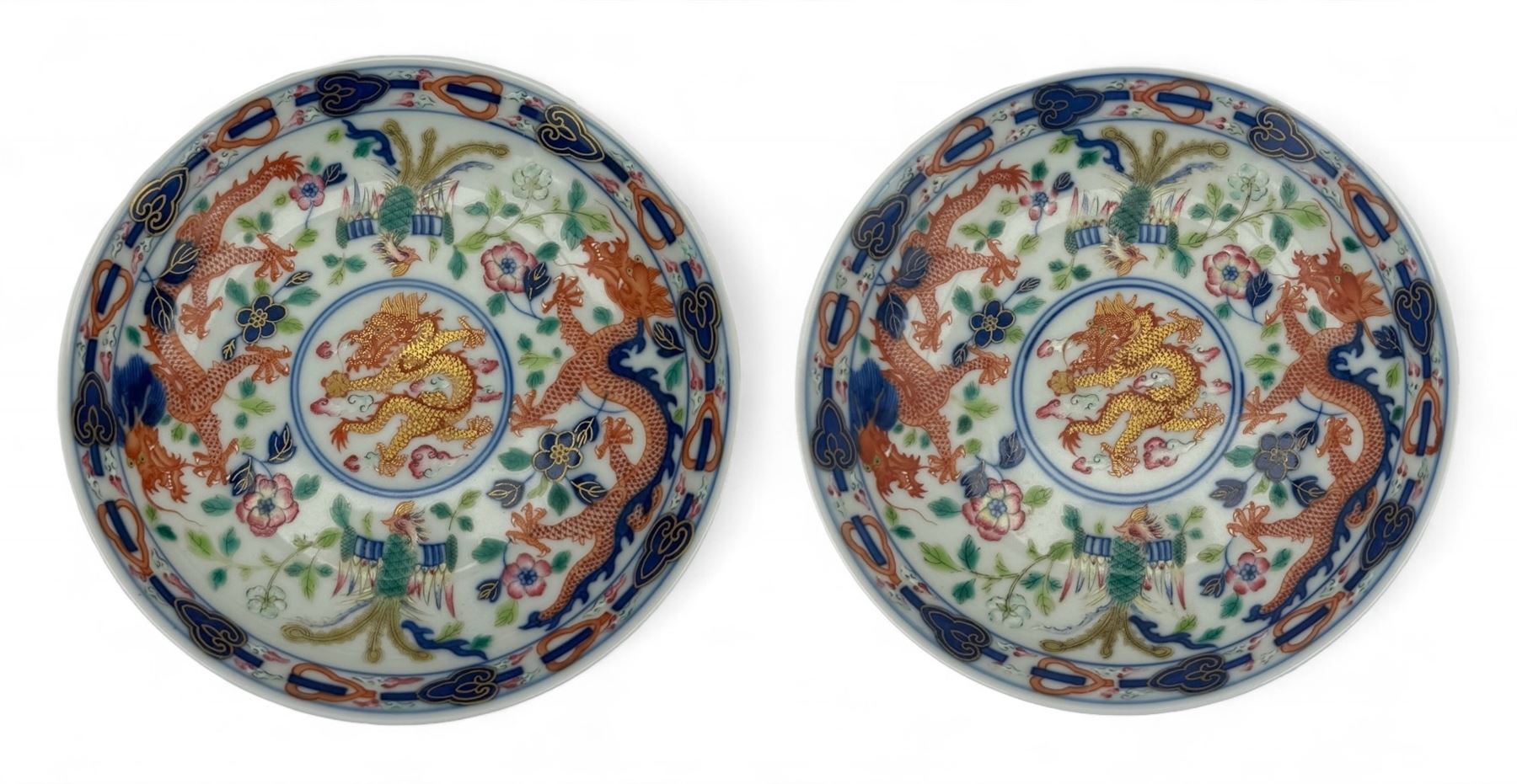 Pair of Chinese 'Dragon & Phoenix' porcelain saucers, centrally painted with a five claw dragon chasing the flaming pearl in iron red and gilt, within a border of confronting Dragons and Pheonix, amongst floral blooms, six character Guangxu mark beneath, D13.5cm