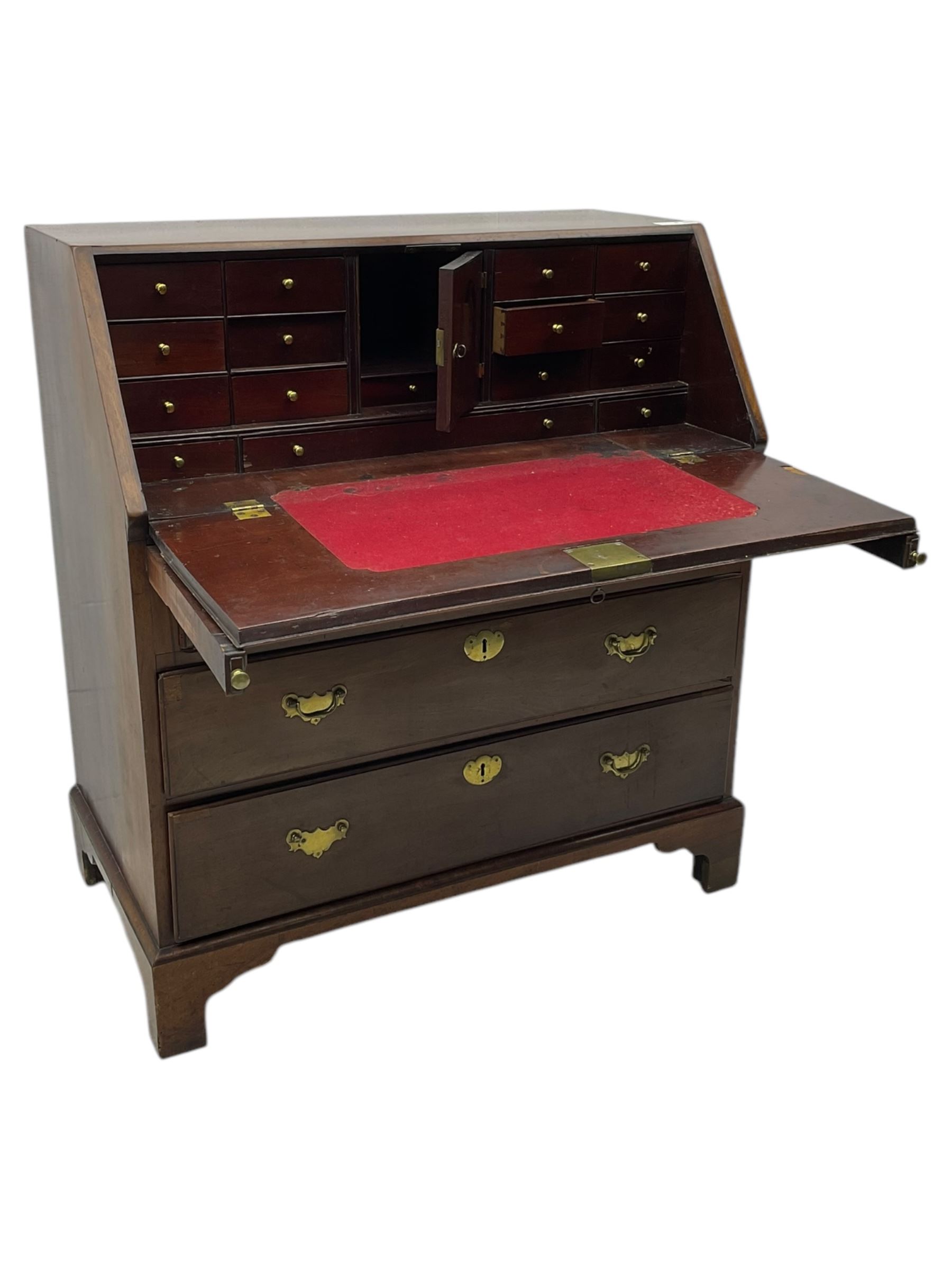 George III mahogany bureau, the fall front enclosing fitted interior, three graduating long drawers, on bracket feet