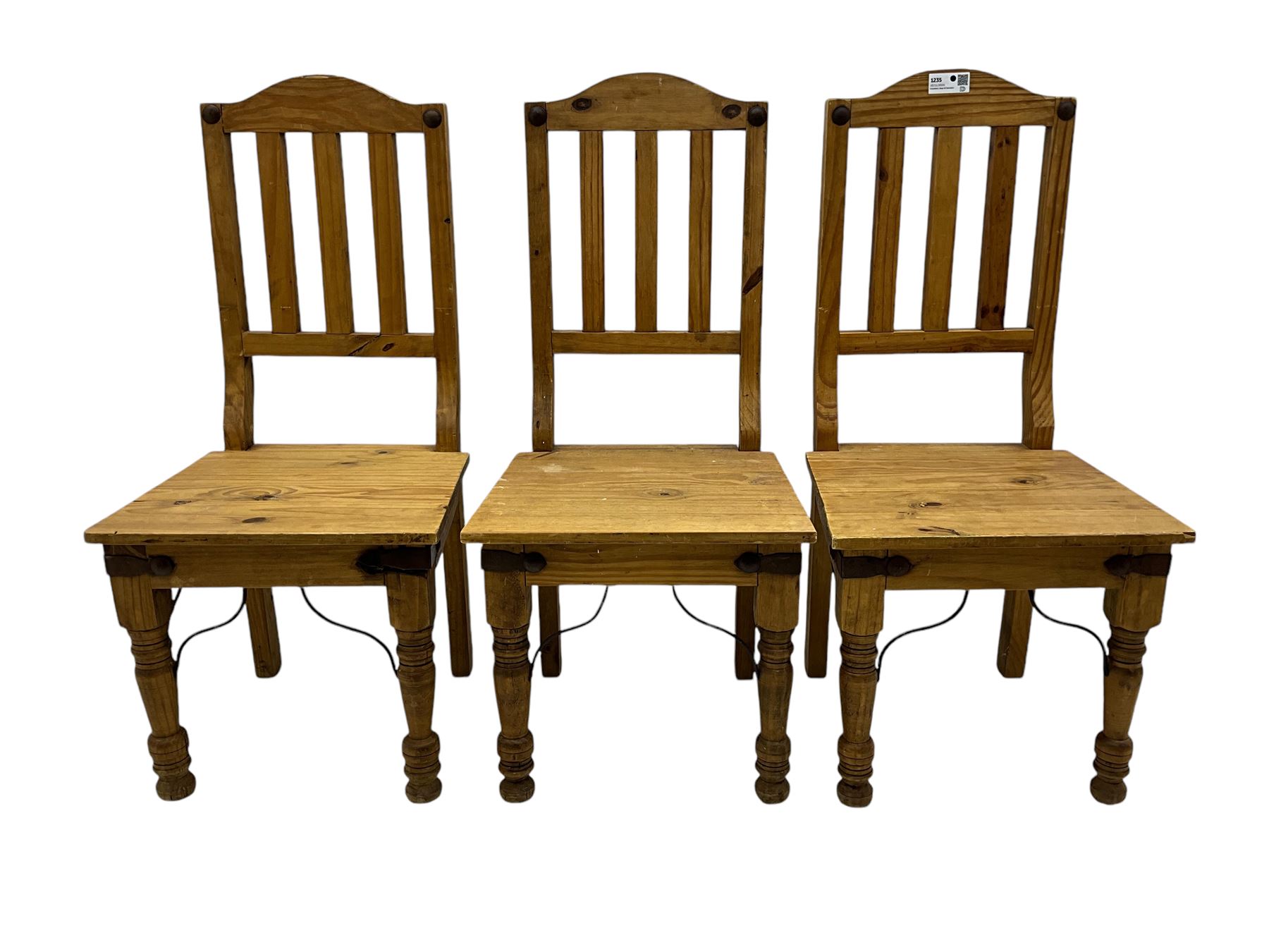 Set of six waxed pine dining chairs, shaped cresting over vertical slat back, plank seat on turned front supports 