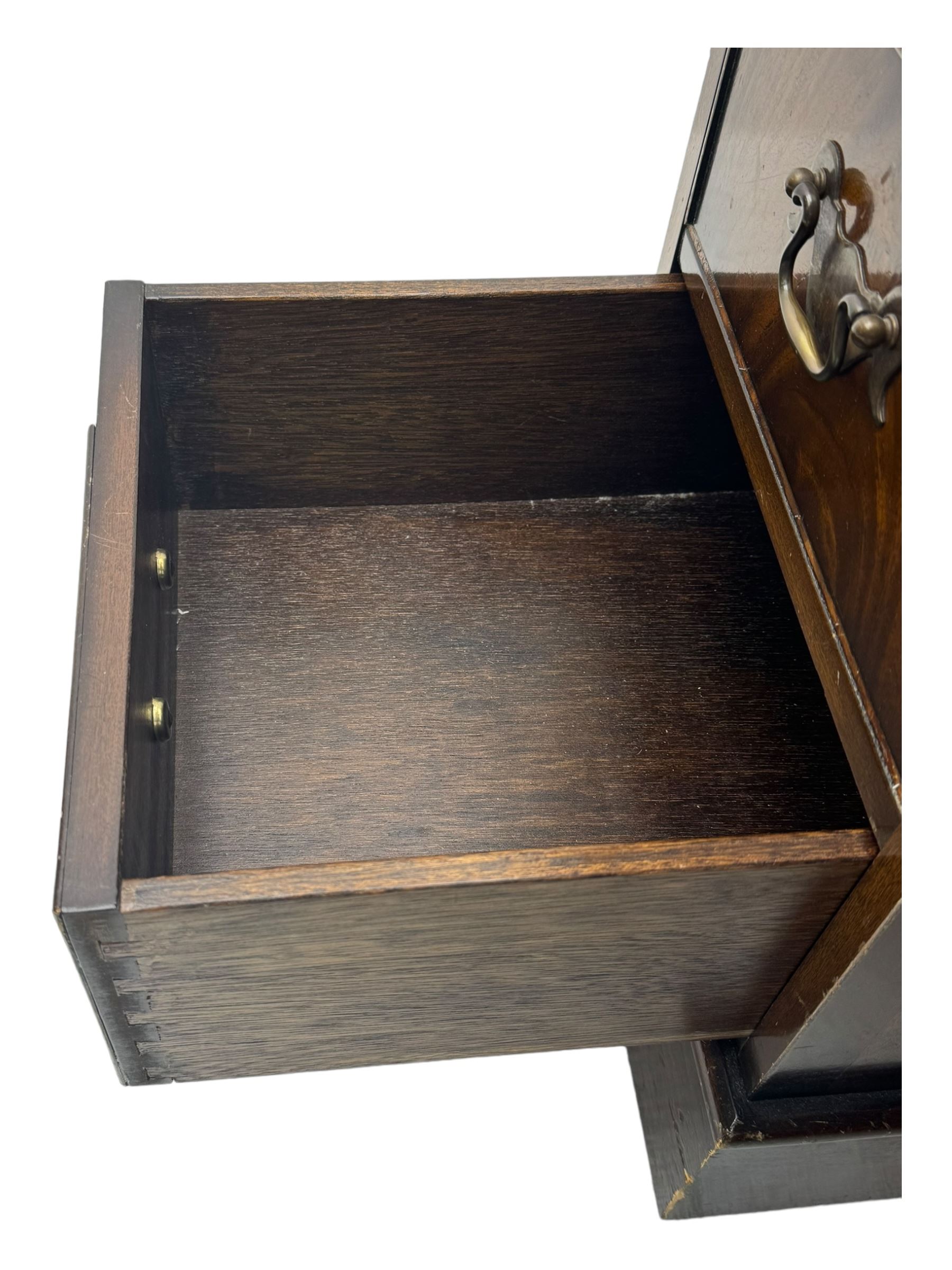 20th century mahogany twin pedestal desk, moulded rectangular top with red leather inset with gilt tooled border, central drawer over kneehole flanked by two banks of four graduating cockbeaded drawers, on plinth base