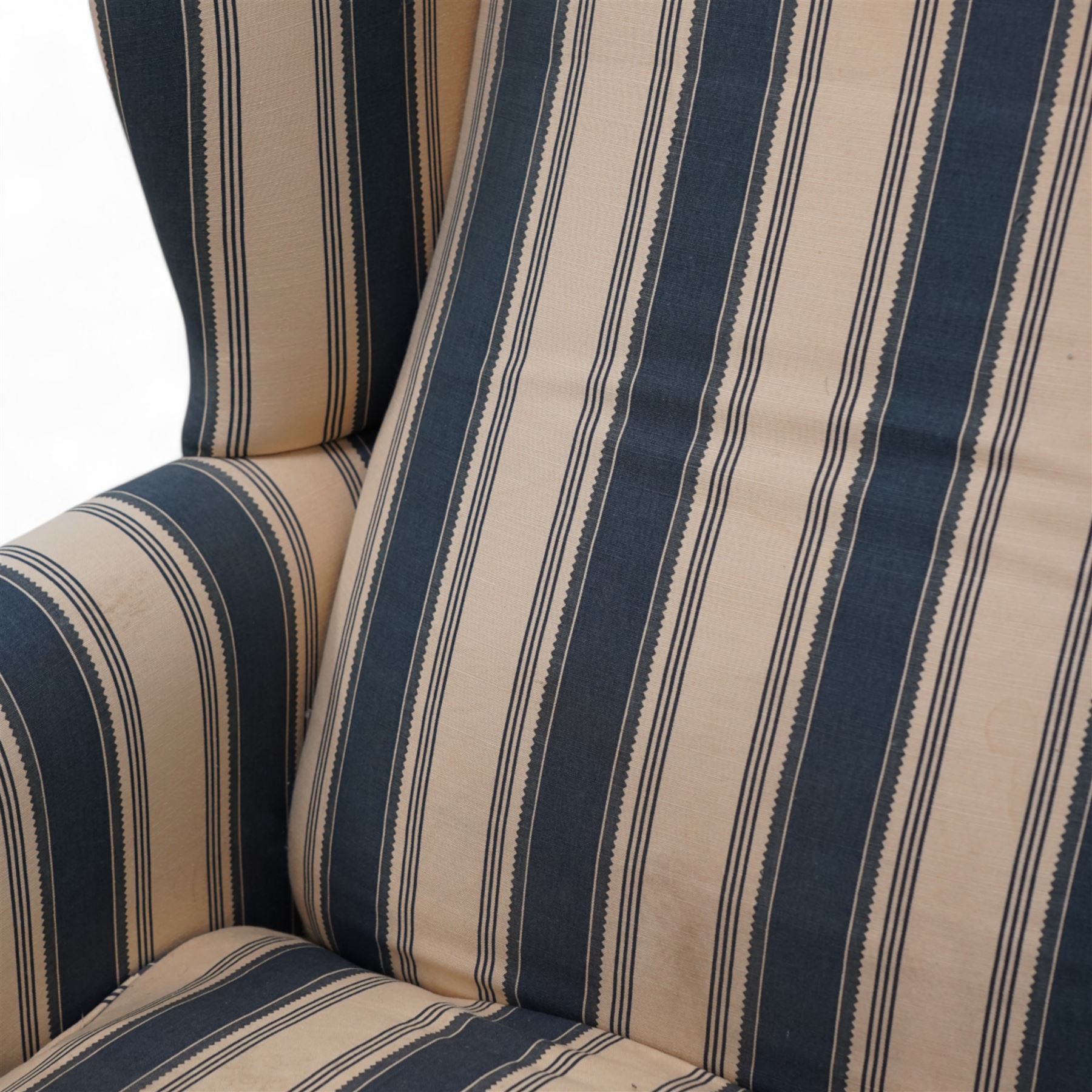 Georgian design wingback armchair, upholstered in blue and cream striped fabric, on shaped supports united by serpentine x-framed stretchers 