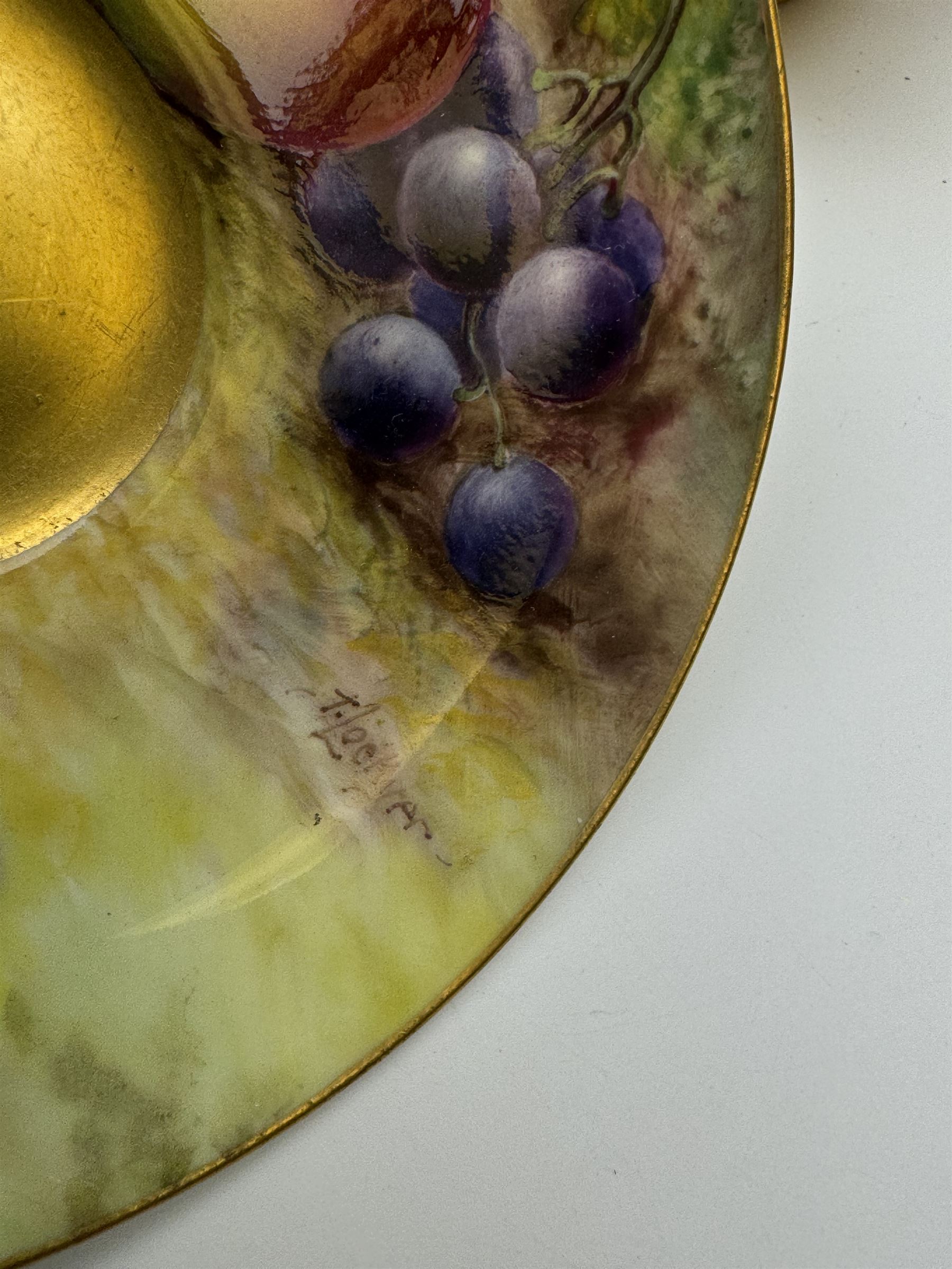 Early 20th century Royal Worcester cup and saucer decorated by Thomas Lockyer, the interior of the cup and the saucer decorated with fruit to a mossy background, with puce printed mark beneath 