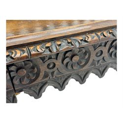 Victorian Gothic revival style carved oak console table, rectangular top with carved edge and raised back gallery, over deeply carved apron with floral and foliate motifs and central drawer, barley twist front supports and plain rear supports united by shaped stretchers, on front bun feet