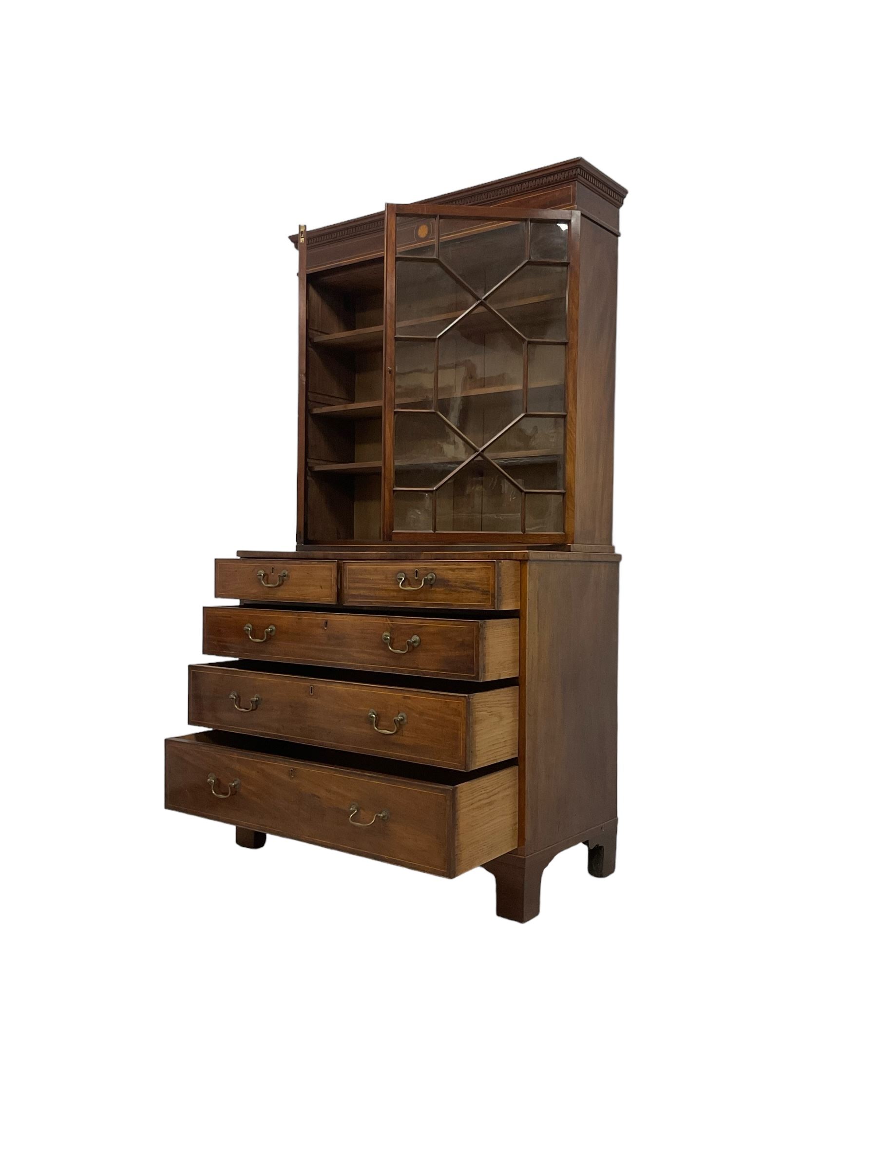 George III mahogany chest of drawers surmounted by a later bookcase, dentil cornice over inlaid frieze and astragal glazed doors, the chest fitted with two short over three long cock-beaded drawers, on bracket feet