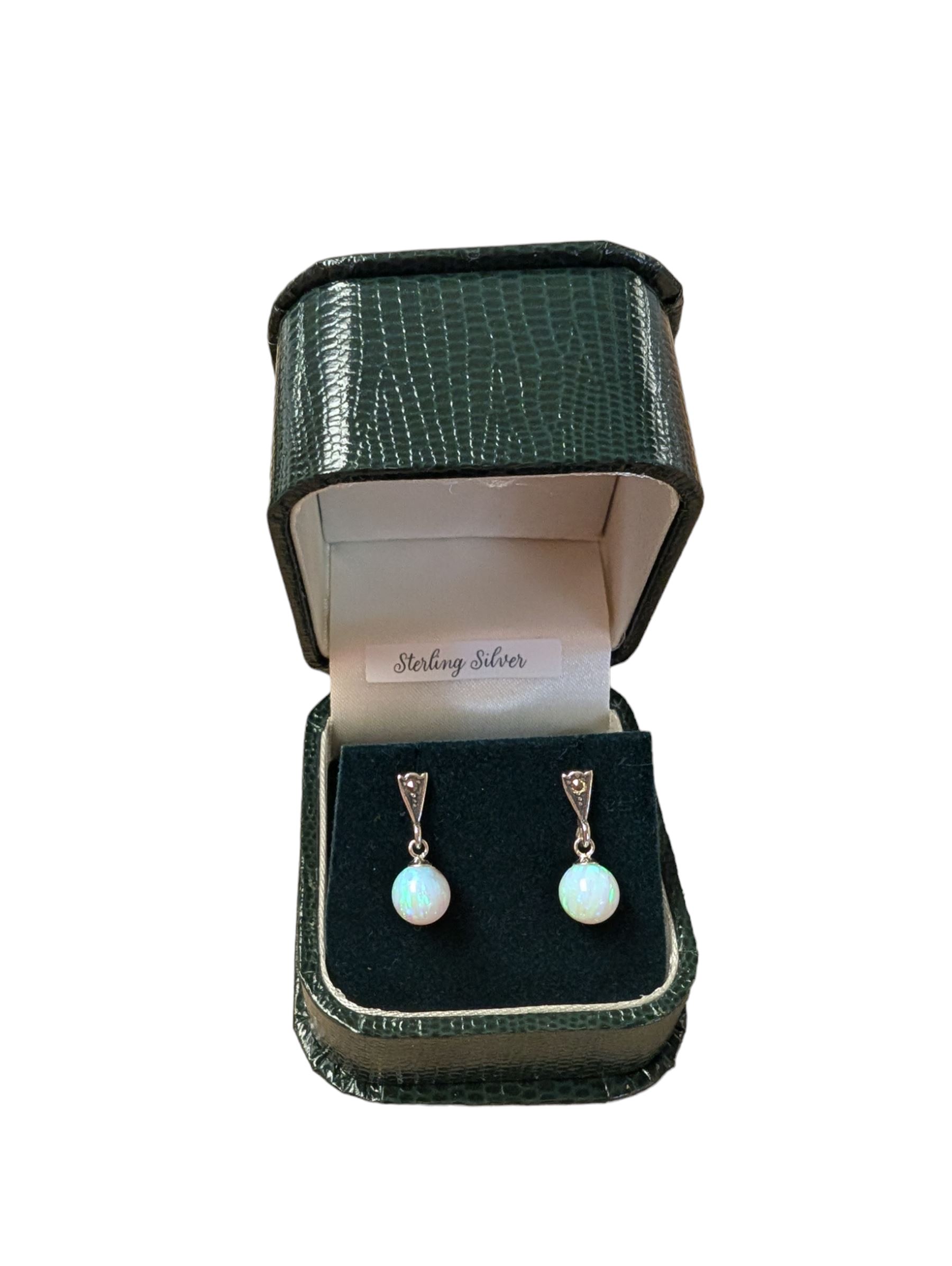 Pair of silver marcasite and opal pendant stud earrings, stamped, boxed 