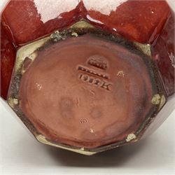 Two Bretby jardinieres, the first example with geometric hexagonal decoration in a red glaze, the second moulded as a flower head, in red glaze with yellow glaze to interior,  both with impressed marks beneath, tallest H25.5cm