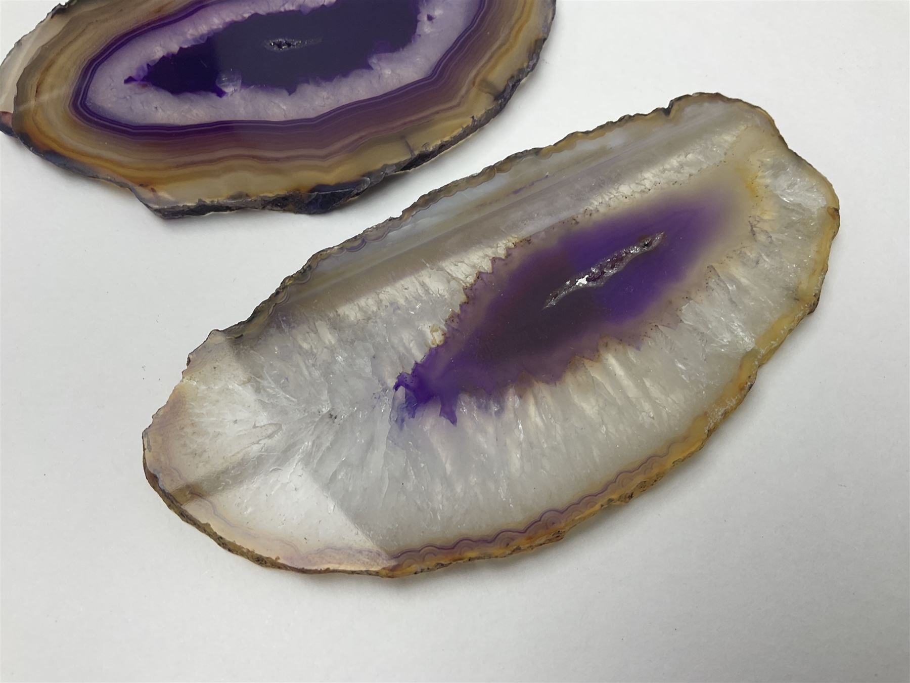 Three purple agate slices, polished with rough edges, of various sizes largest H7cm, L10cm