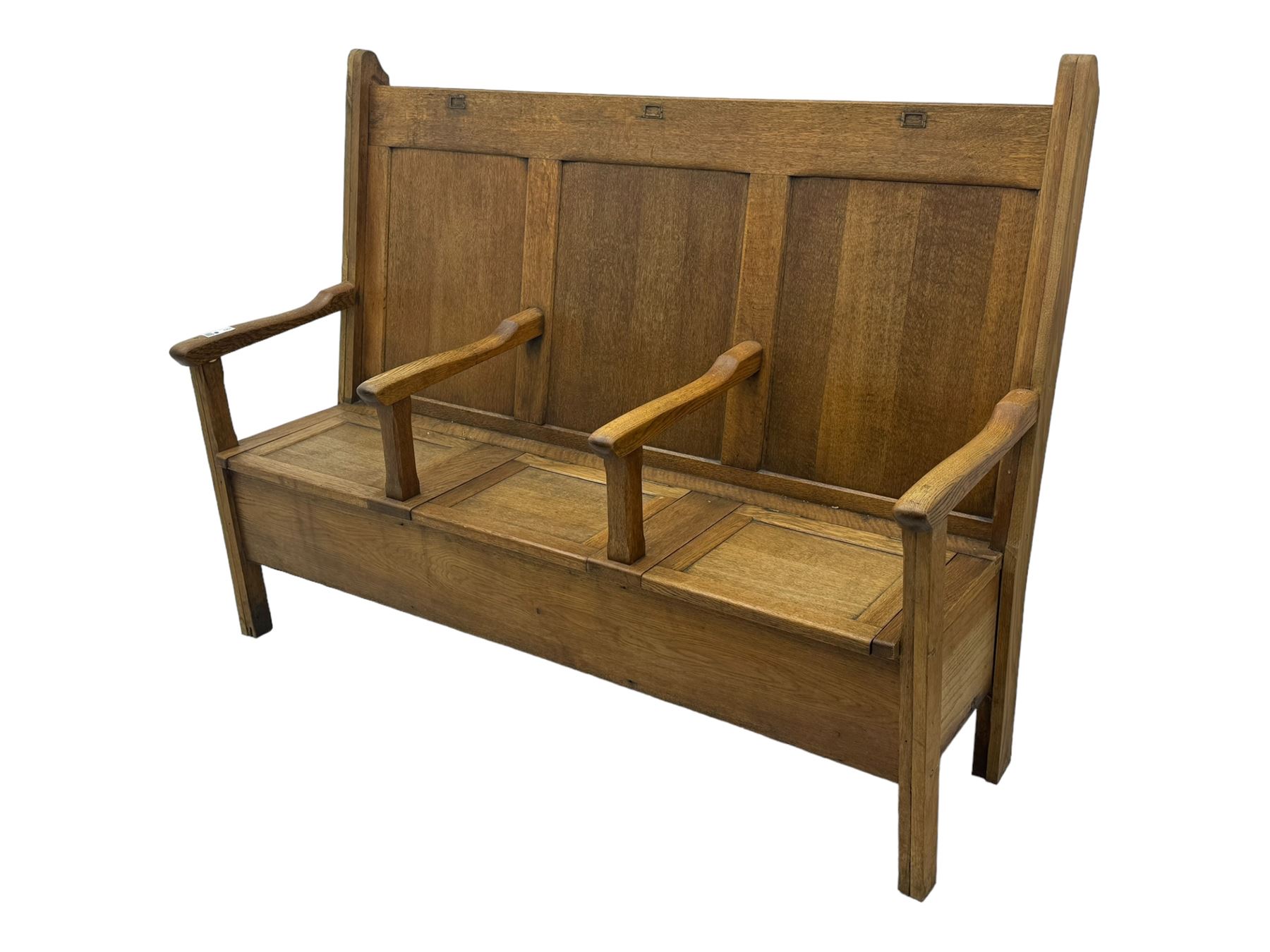 Early 20th century oak settle, featuring a high back with three panel sections and hinged lids, the bench seat divided into three sections, each with its own armrests, supported by square legs