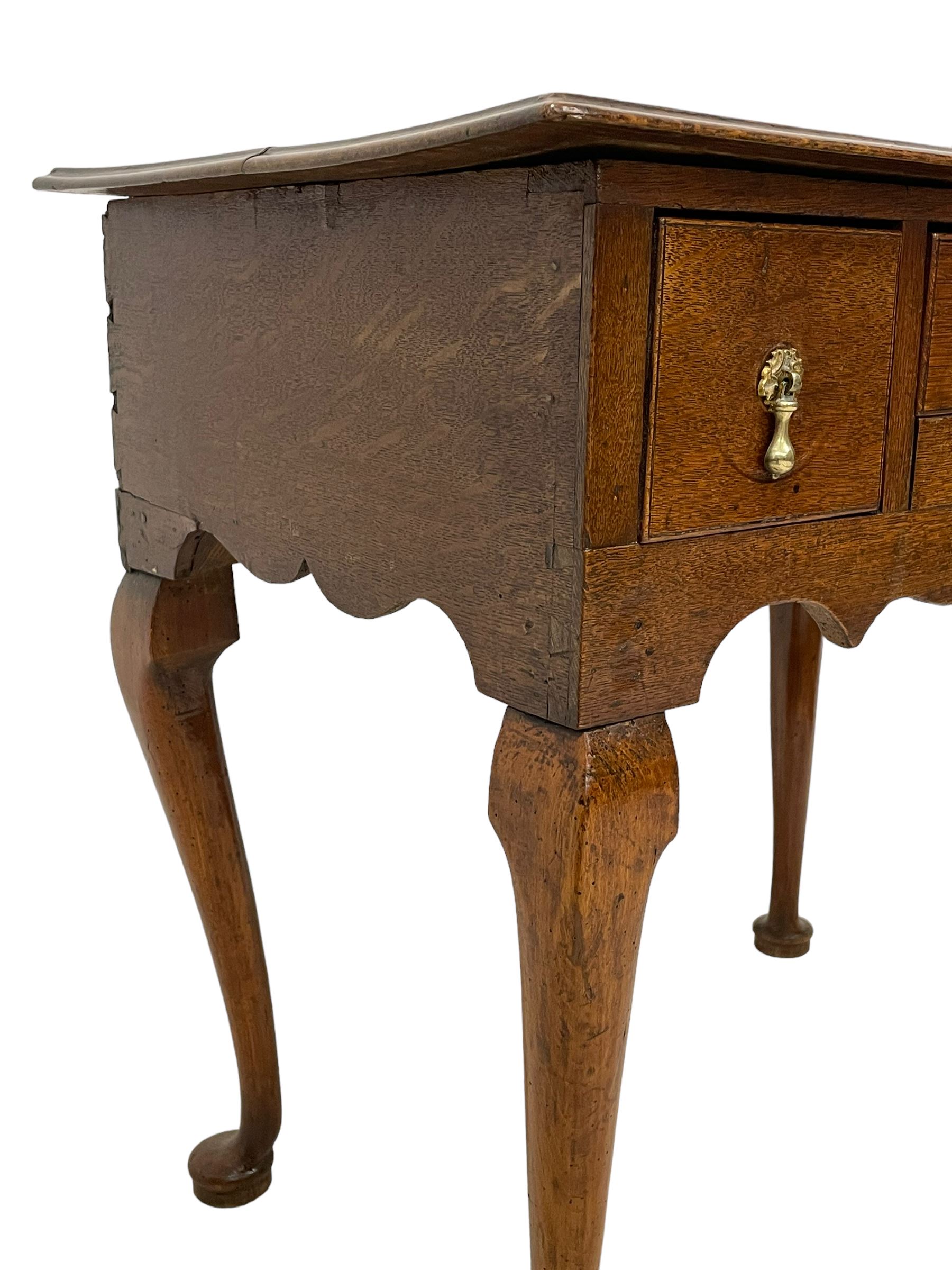 18th century oak low-boy, rectangular moulded top over three drawers with scratch mouldings, shaped apron, on cabriole supports