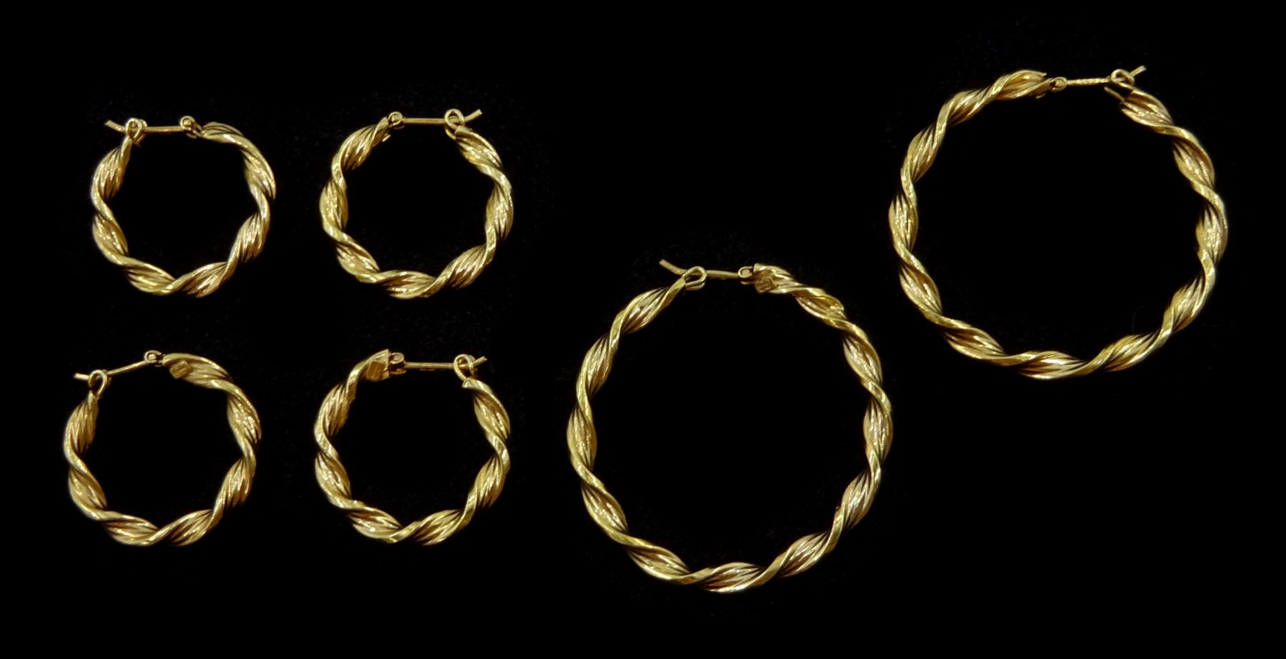 Three pairs of 9ct gold twist hoop earrings, stamped 375