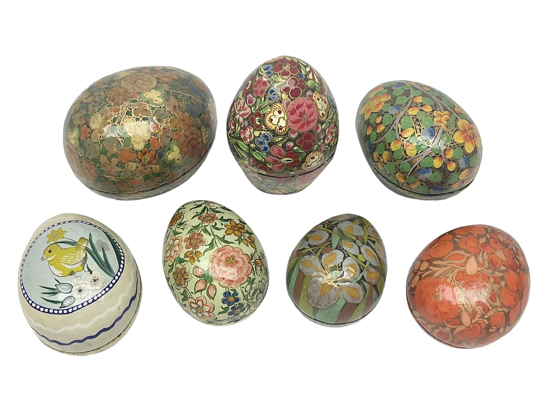 Seven lacquered boxes, of ovoid form, with floral decoration, largest H7cm, L10cm