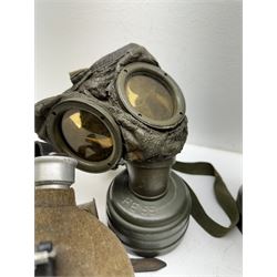 Two WWII German army canteen water bottles, together with German gas mask marked FE55 in a green fluted tin canister