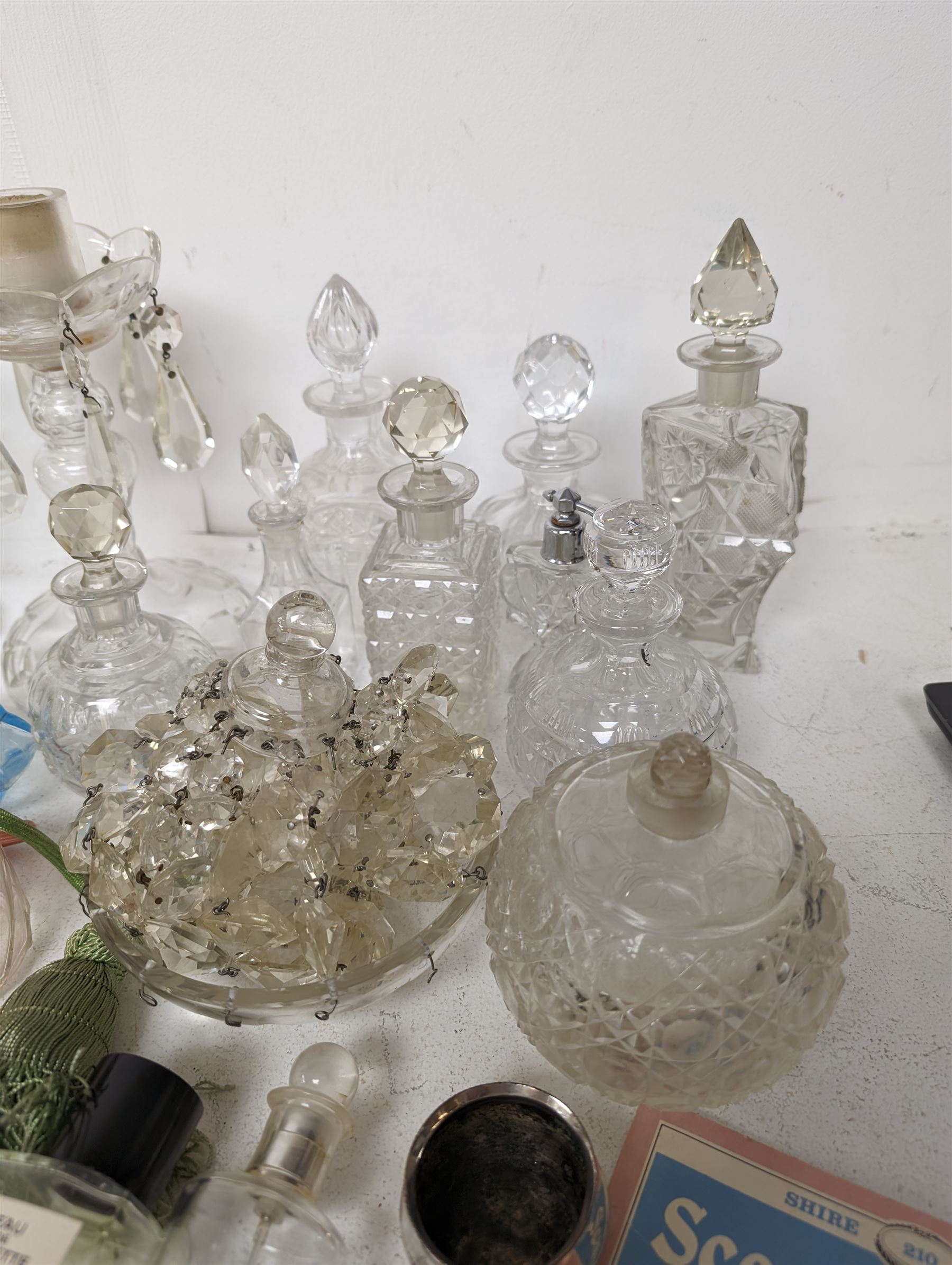 Pair of glass lustre candlesticks, together with a collection of lustre droplets and Victorian and later cut glass scent bottles