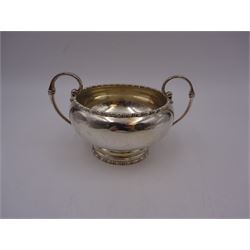 Early 20th century silver twin handled bowl, of plain bellied form with bead and dart rim and two C scroll handles, upon a circular foot, hallmarked Walker & Hall, Sheffield 1919, including handles H9.5cm