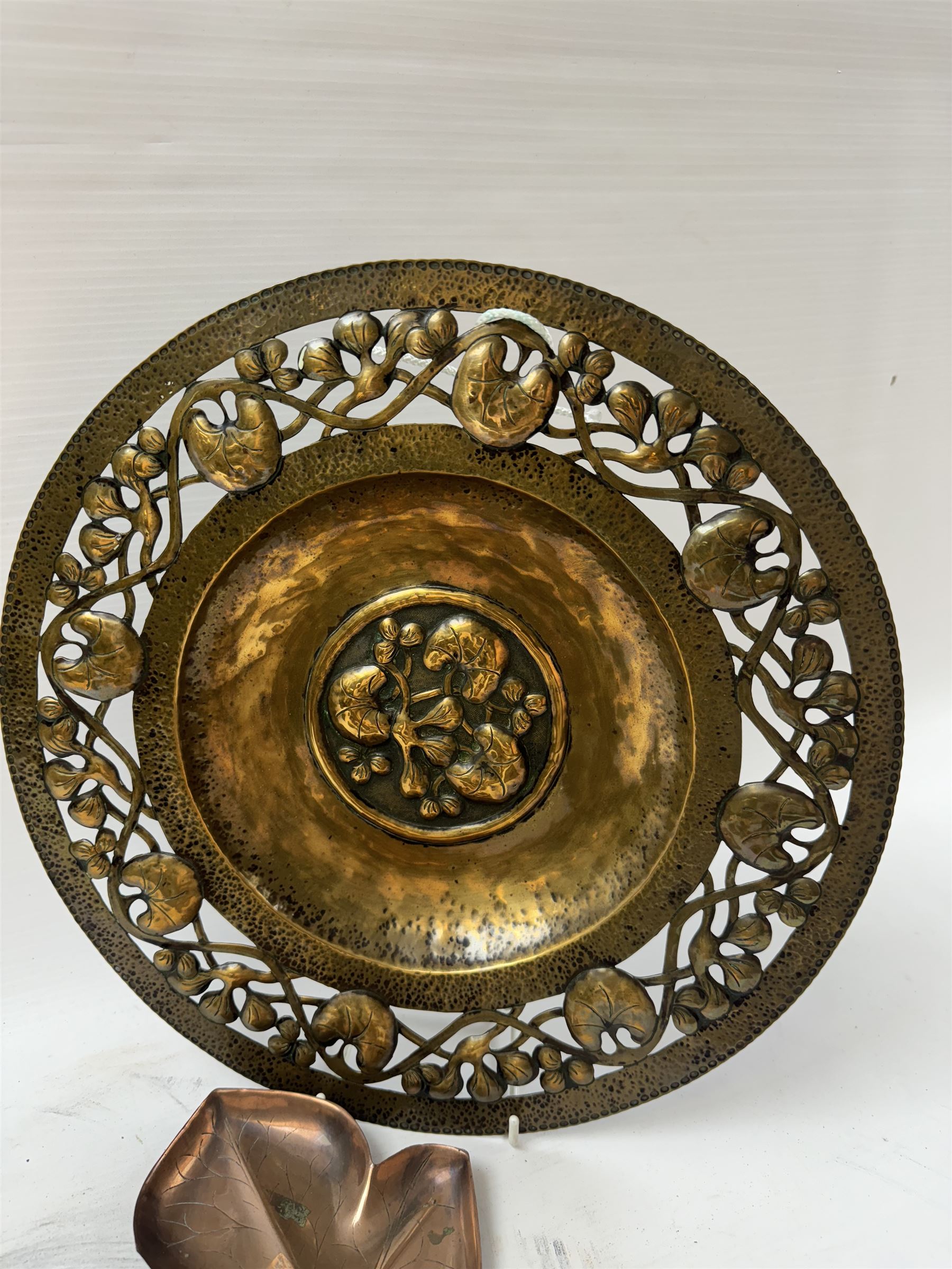 Keswick School of Industrial Arts, flared vase of cylindrical form, together with an Arts and Crafts plated copper, an embossed tray, copper dishes and charger 