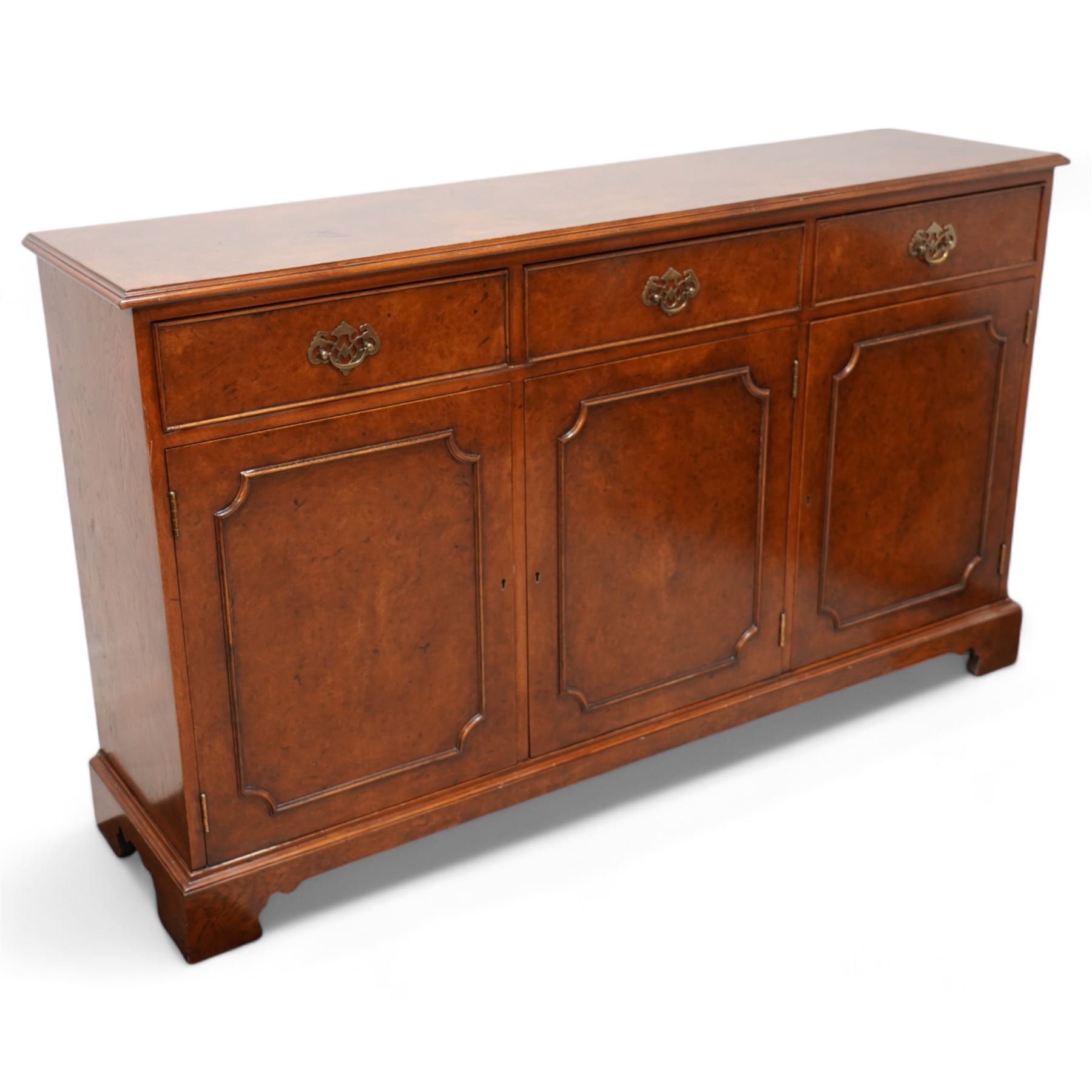 Georgian design figured walnut sideboard, moulded rectangular top over three drawers and three cupboards, on bracket feet 