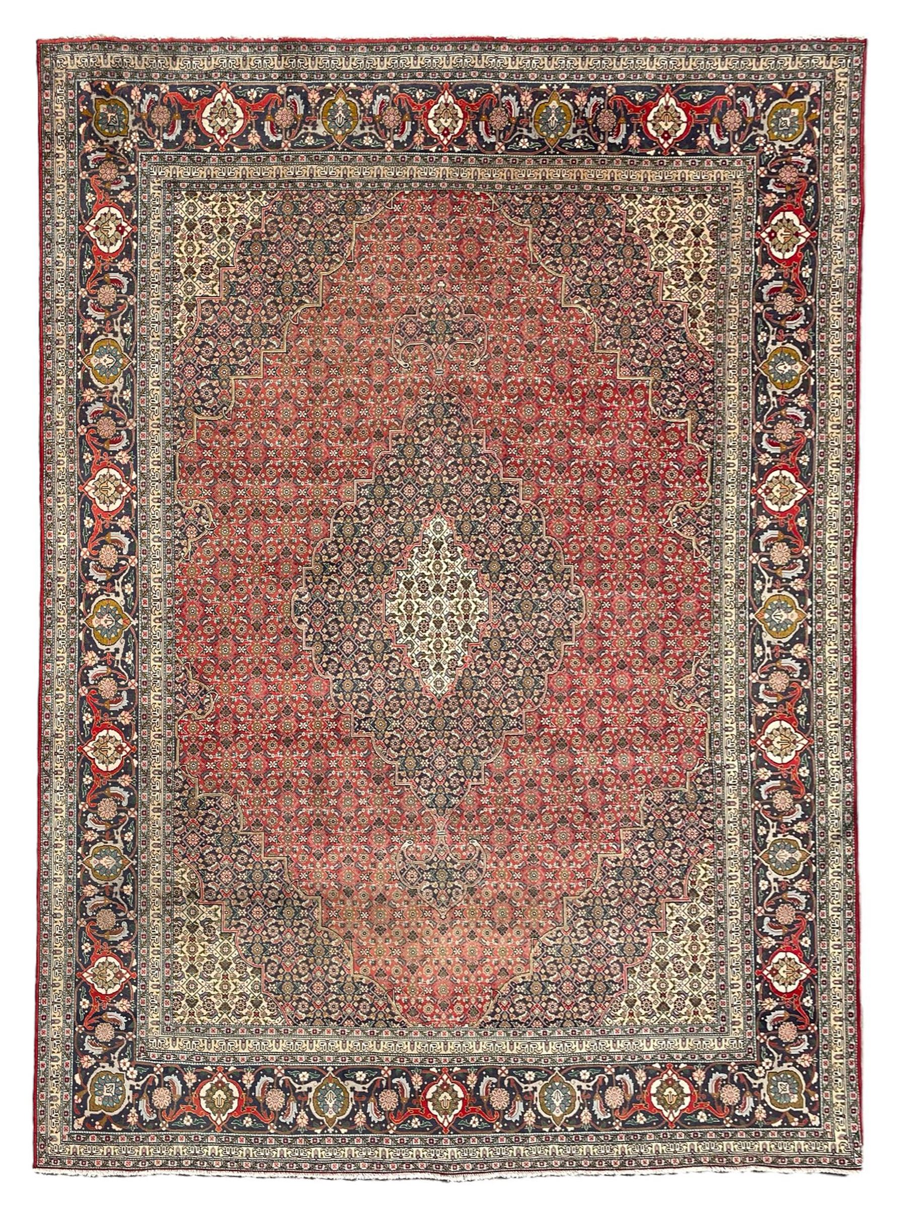 Perisian Bidjar crimson ground rug, within scalloped borders, central pole medallion, the field decorated all over with floral Herati motifs, guarded border decorated with repeating stylised plant motifs and trailing branch 