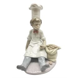Lladro figure Chef's Apprentice, modelled as a young boy in Chef's whites with a sack of potatoes, sculpted by Antonio Ramos, no 6233, with original box, year issued 1995, year retired 1998, H20cm