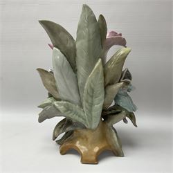 19th century Scheibe vase, modelled as a large open bud supported against and upon leaves on which perch three children in various poses, the whole upon feet modelled as leaves and branches, with blue KPM and cross mark beneath, H26cm