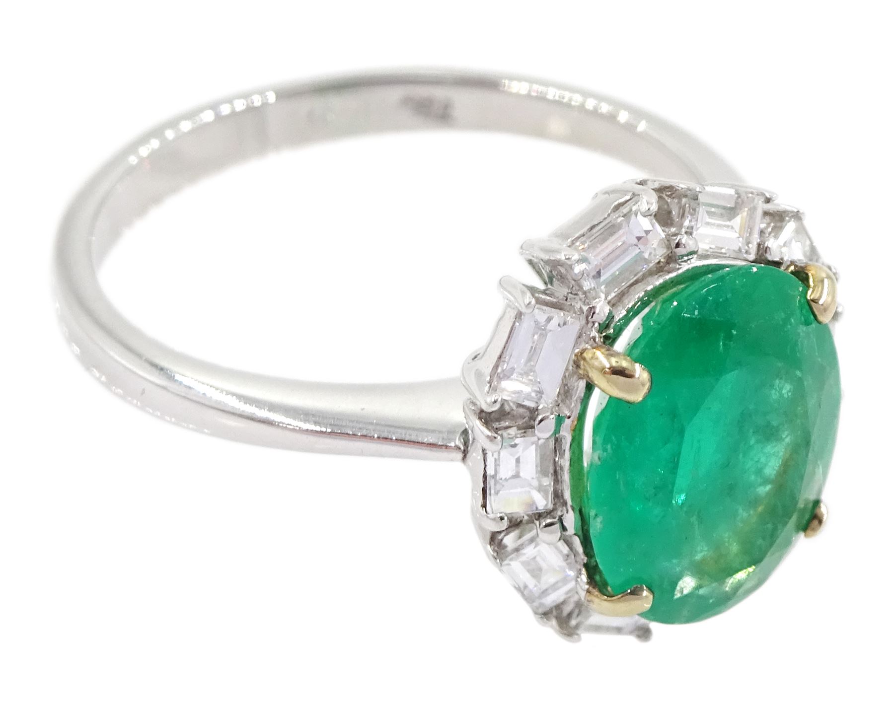 18ct white gold oval cut emerald and baguette cut diamond cluster ring, stamped 750, emerald approx 2.05 carat, total diamond weight approx 0.40 carat