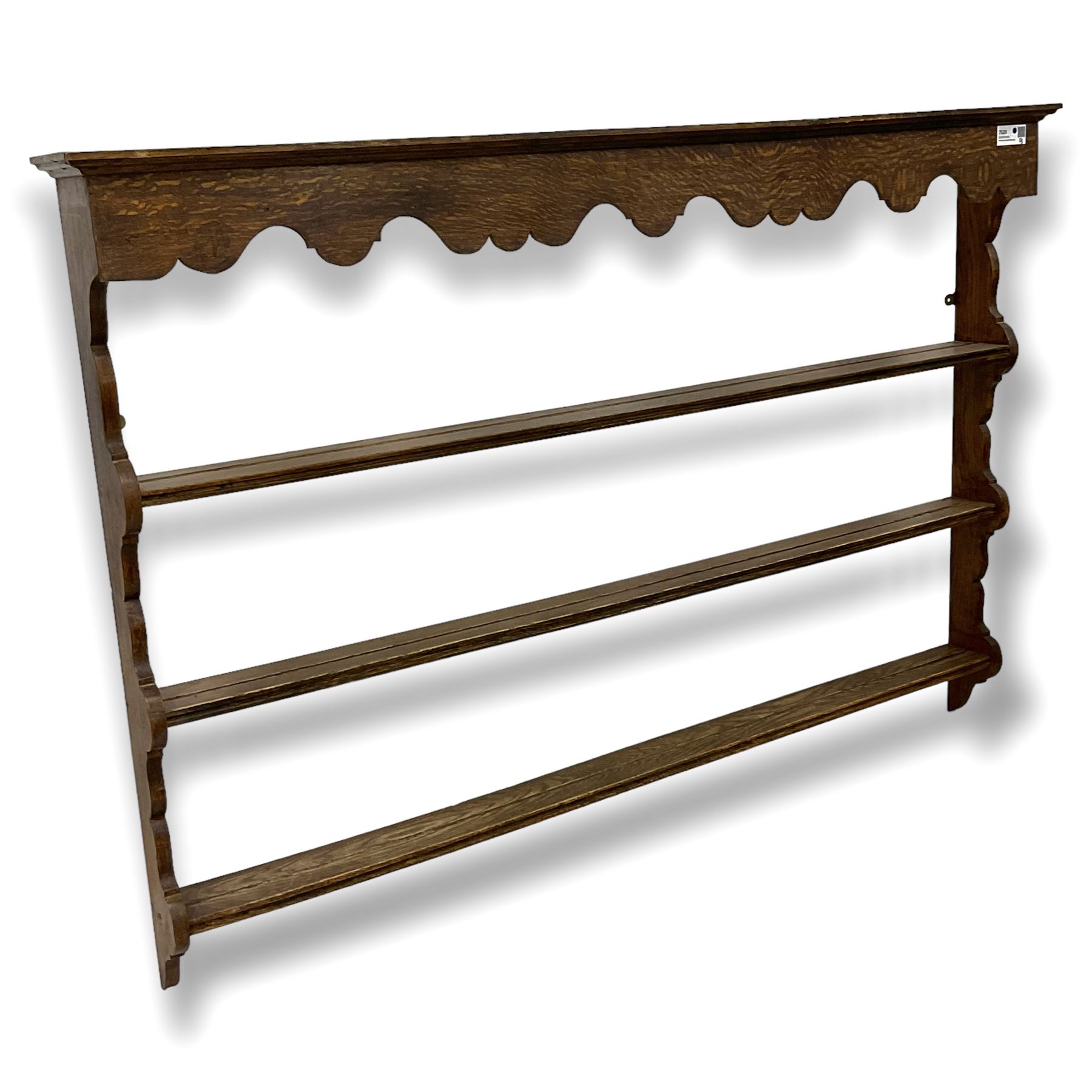 Early 20th century oak wall hanging Delph rack, applied moulded cornice over shaped frieze, three-tiers supports by shaped end supports