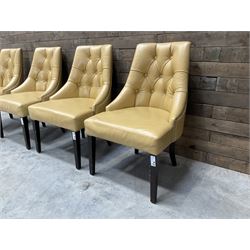 Four high back chairs upholstered in buttoned beige leather, studded detail, rosewood legs