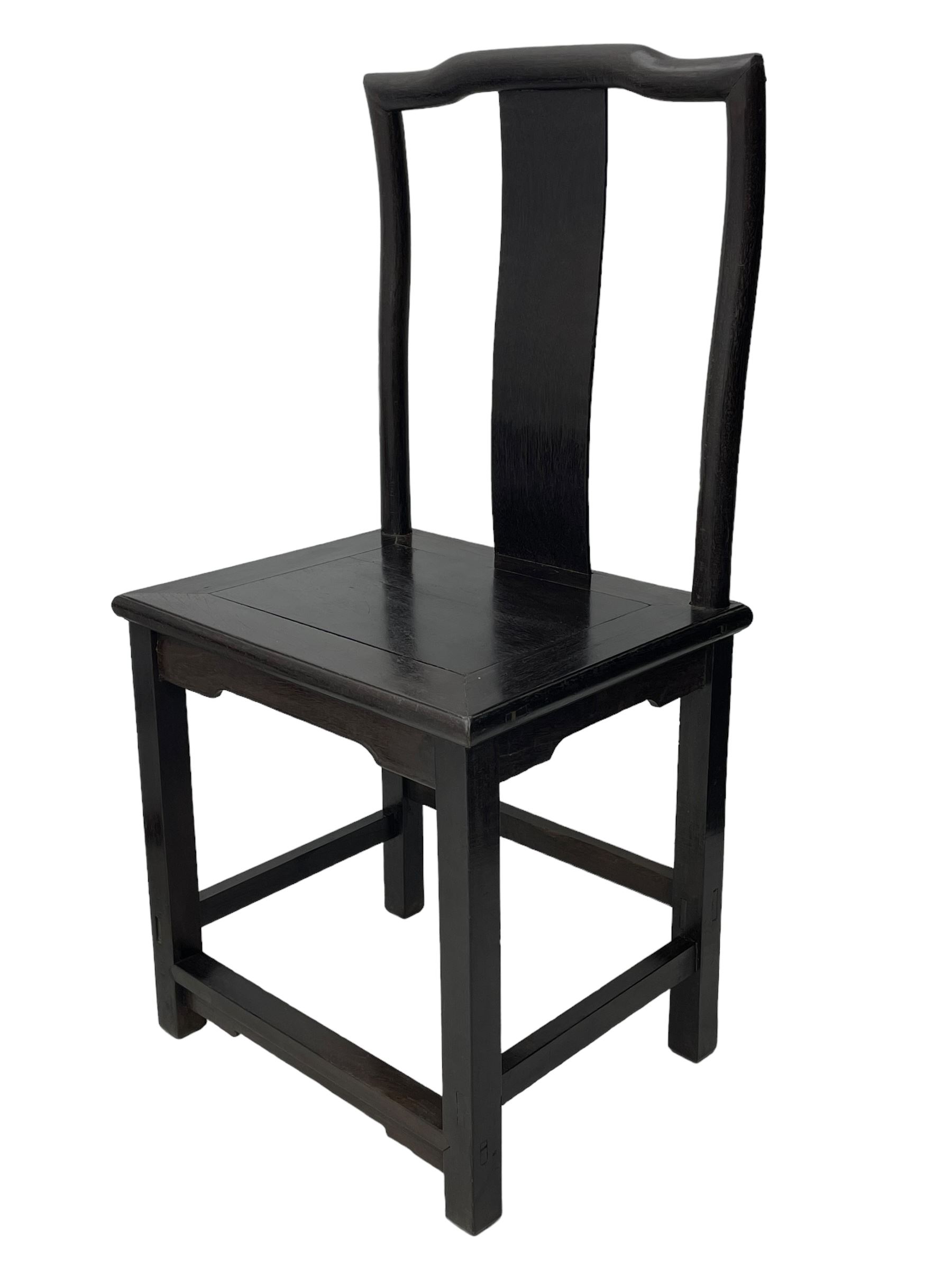 Pair of early 19th century Chinese Qing dynasty black wood side chairs, yoke cresting rail over shaped back panel, panelled rectangular seat on square supports united by stretchers 