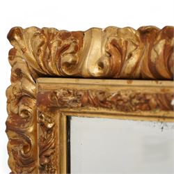 19th century gilt and gesso framed wall mirror, the rectangular beveled plate within an acanthus ribbon-twist moulded inner frame with moulded rose motifs, the outer frame decorated with moulded curling acanthus leaves