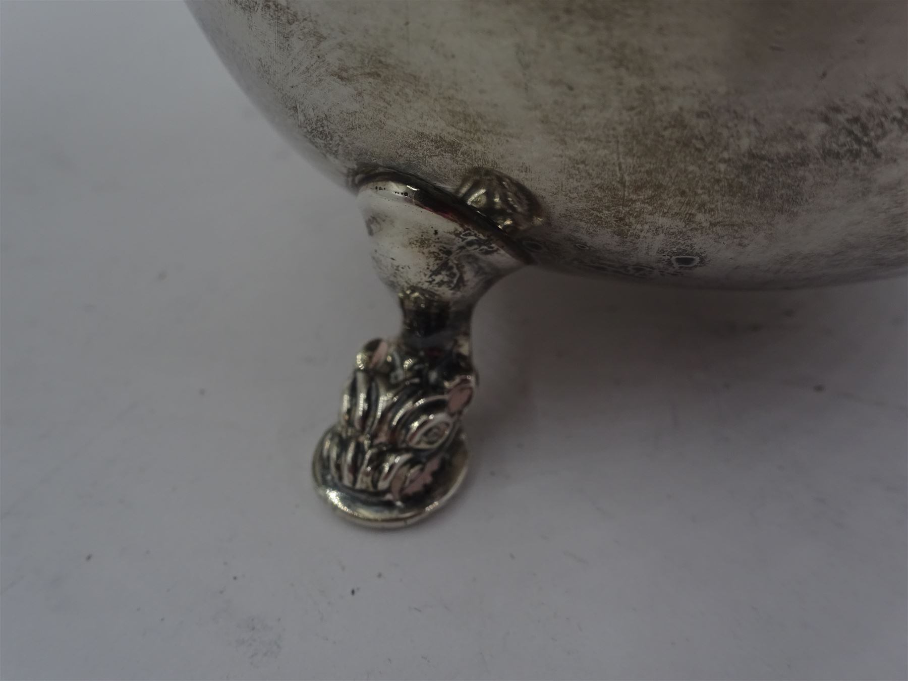 Early 20th century silver sauce boat, of typical form with flying scroll handle, the handle and feet modelled as Viking style dragon heads, hallmarked Adie Brothers Ltd, Birmingham, date mark indistinct, possibly 1940, including handle H9cm