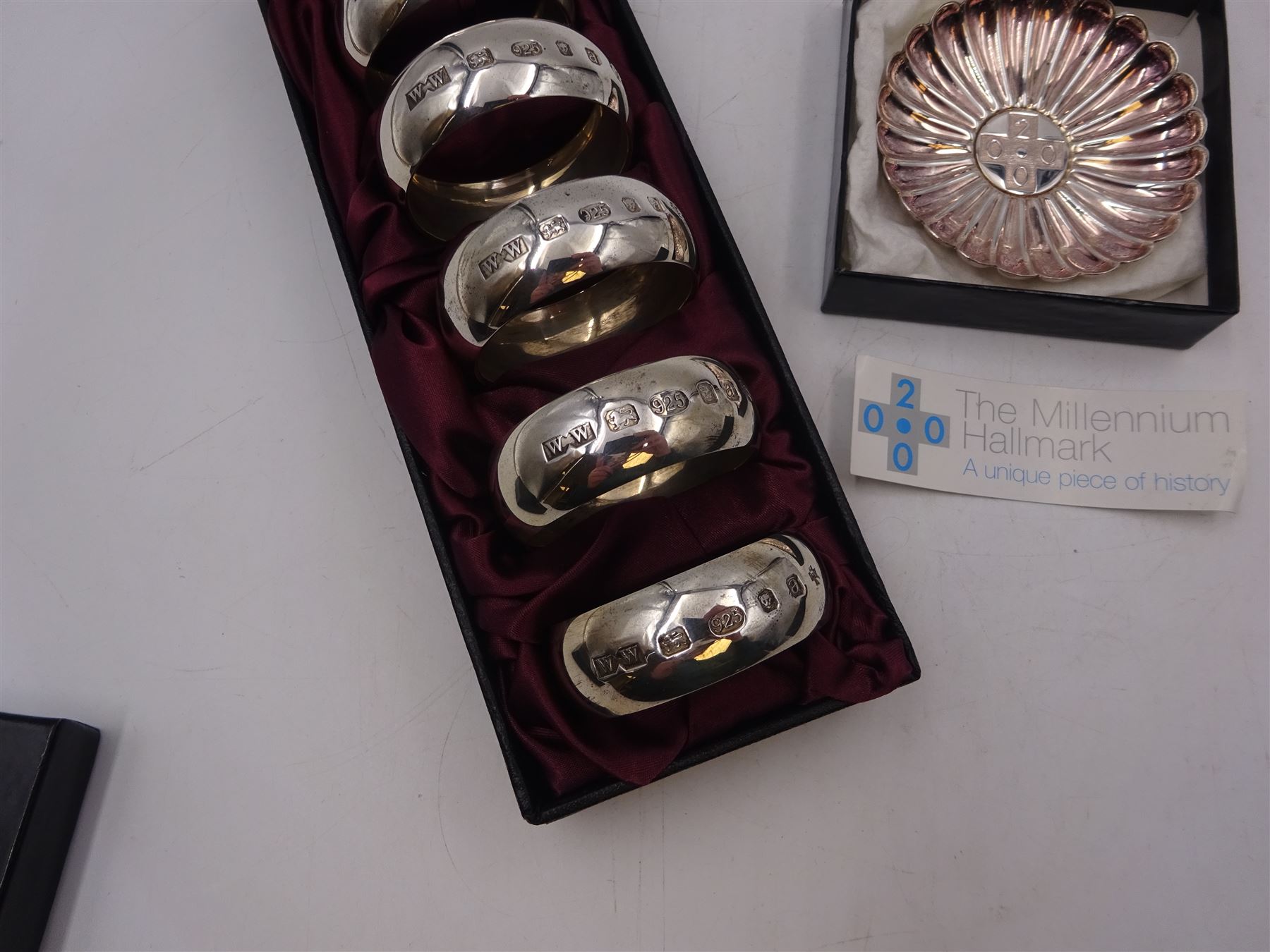 Set of six modern silver napkin rings, hallmarked London 2000, makers mark WW, together with a modern silver pin dish, hallmarked Hugh Crawshaw, Sheffield 2000, both boxed